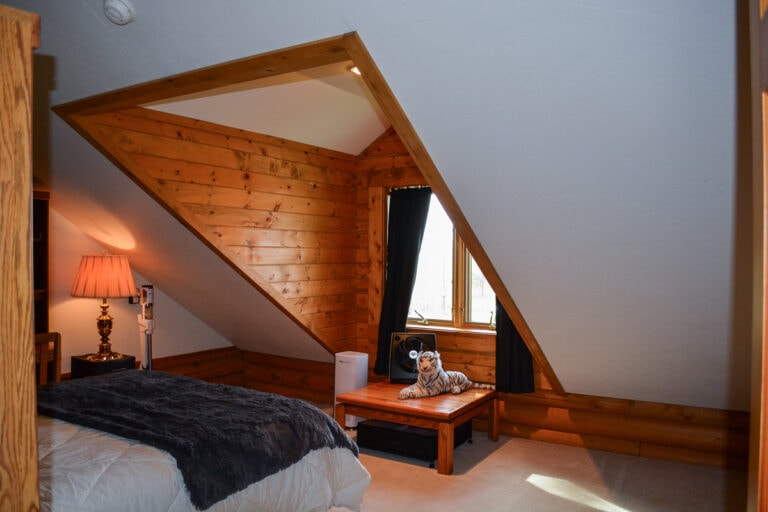 Wooden siding on a gable roof in an upstairs bedroom