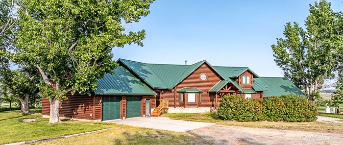 Log home with garages and green roof on Ballantine MT horse property for sale